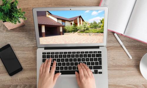 woman using laptop to shop for a home