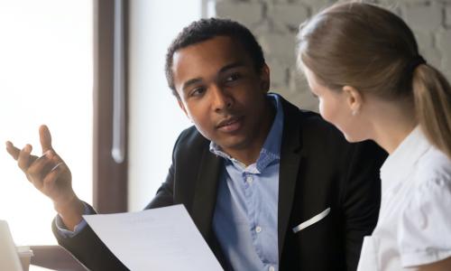 African American man and white woman in a conversation 