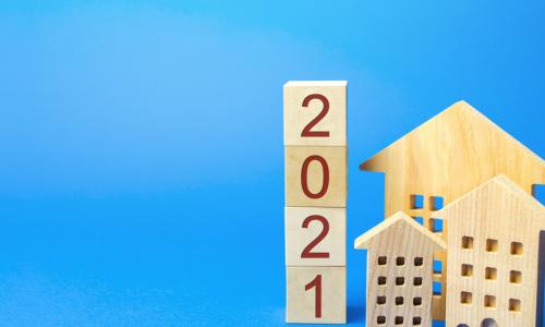 wooden blocks of houses and the year 2021