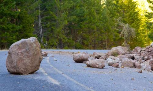 boulder and rock slide debris in the road