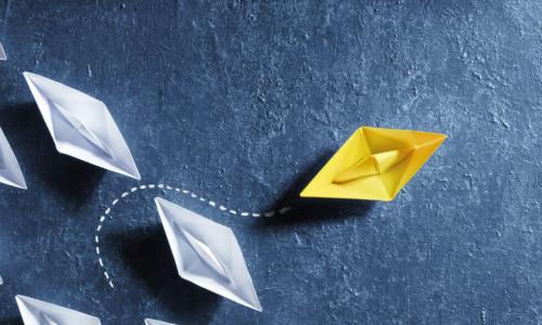 yellow paper boat pivots out of line of white boats