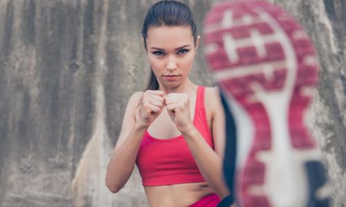 young woman kicking