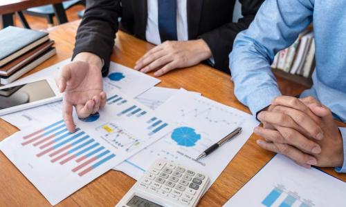 executives at a table doing financial planning