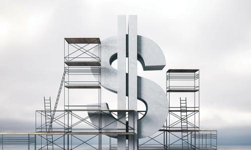 stone dollar sign surrounded by scaffolding in front of cloudy sky