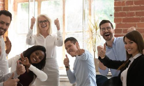 diverse executives with thumbs up