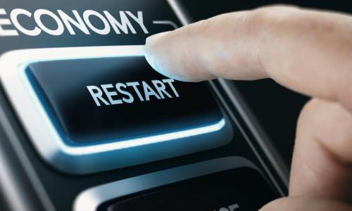 man pressing economic restart button