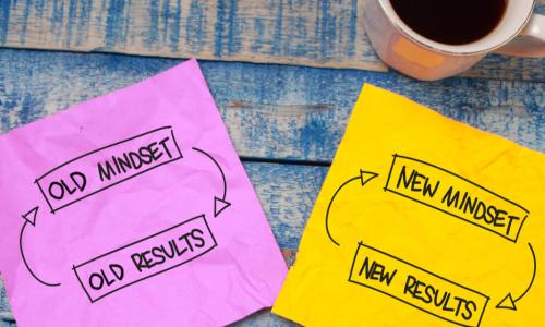 brightly colored napkins on table with words mindset and outcome