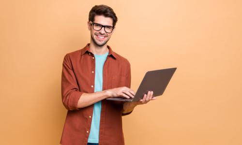 smiling man with laptop