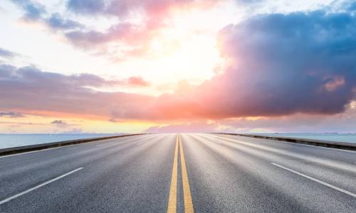 road leading to sunset on the horizon