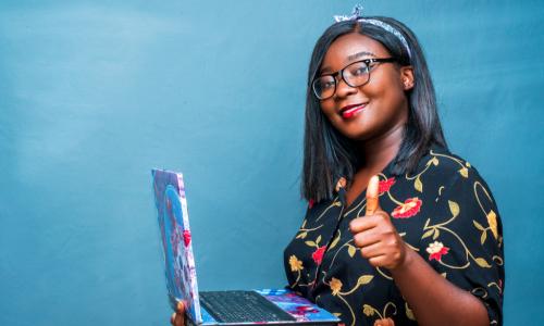 Black woman with her laptop giving a thumbs up