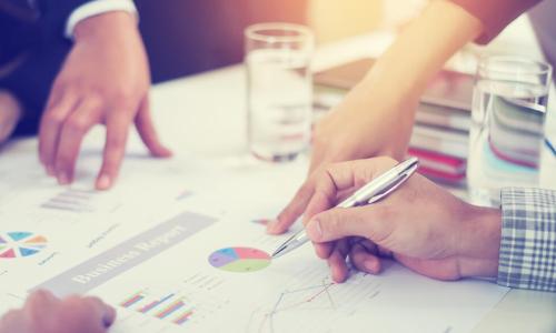 executives work on financials at table