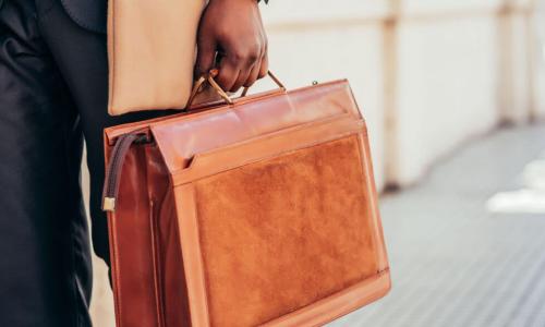 businessman walks with briefcase