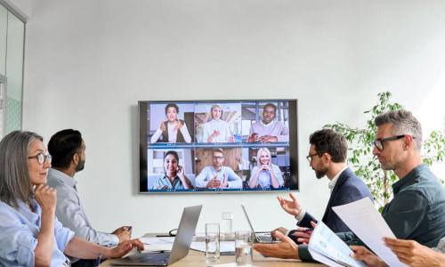 diverse board meeting with some people online and some in person