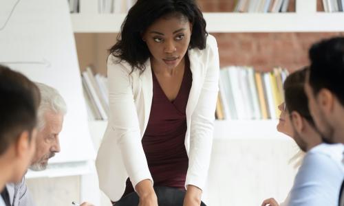 young Black woman leads board meeting