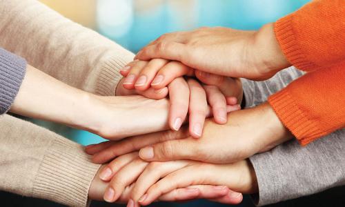 hands stacked together to show solidarity