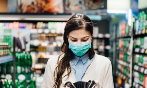 shopper with wallet in grocery aisle