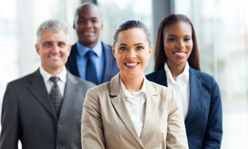 a group of four executives stand together