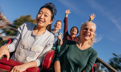 Young people on a thrilling roller coaster ride